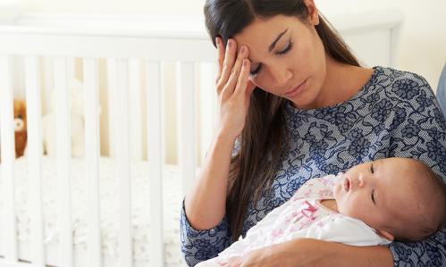 Tired Mother suffering from postpartum depression